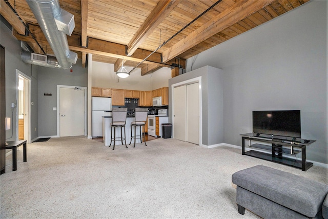 living room featuring wooden ceiling, beamed ceiling, light colored carpet, and a high ceiling