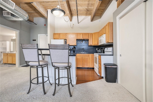 kitchen featuring beam ceiling, white appliances, sink, and wooden ceiling