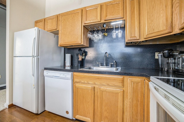 kitchen featuring backsplash, sink, dark wood-type flooring, and white appliances