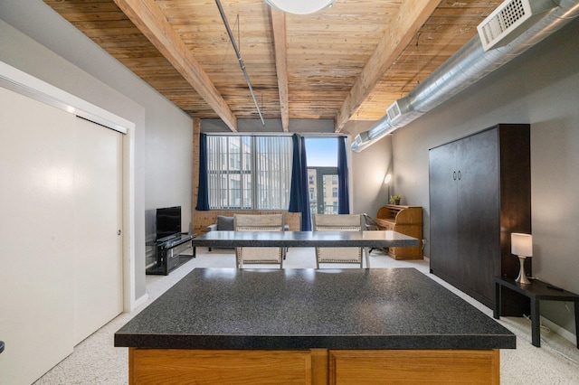 kitchen featuring beam ceiling, a kitchen island, and wood ceiling