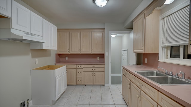 kitchen featuring sink and light tile patterned floors