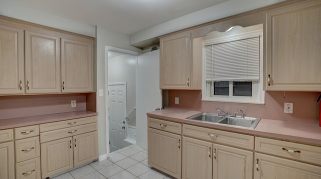 kitchen featuring light tile patterned flooring, sink, and light brown cabinets