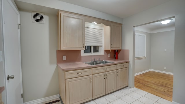 kitchen featuring light brown cabinetry, light hardwood / wood-style flooring, and sink