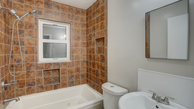 full bathroom featuring sink, toilet, and tiled shower / bath