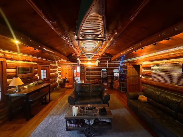 interior space featuring hardwood / wood-style flooring, beam ceiling, and log walls