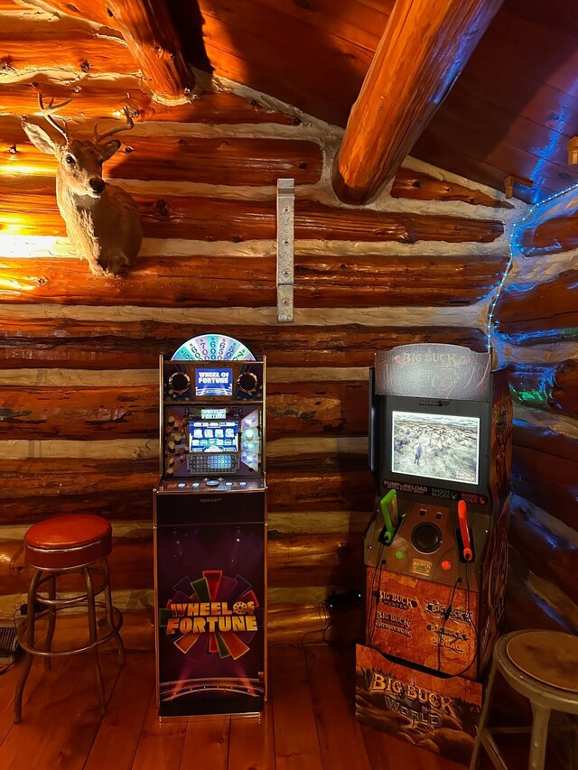 room details featuring log walls and wood-type flooring