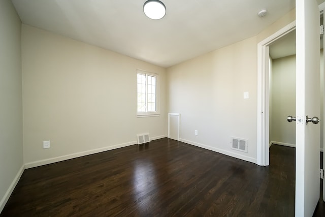 spare room featuring dark hardwood / wood-style flooring