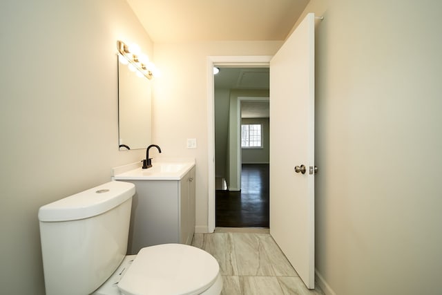 bathroom with vanity, hardwood / wood-style flooring, and toilet