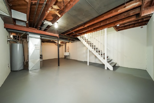 basement with heating unit, sink, and water heater