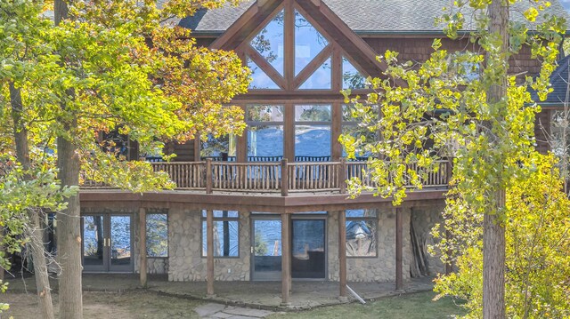 10560 Plaza Ct, Jerome, MI 49249 - rear view of property with stone siding, a shingled roof, a deck, and french doors