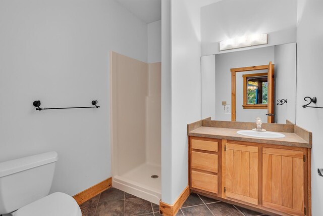 10560 Plaza Ct, Jerome, MI 49249 - bathroom featuring toilet, baseboards, a stall shower, vanity, and tile patterned floors
