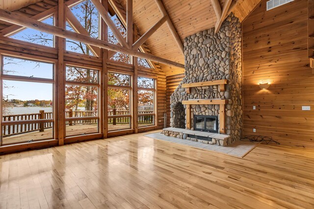 10560 Plaza Ct, Jerome, MI 49249 - unfurnished living room with high vaulted ceiling, wood ceiling with exposed beams, hardwood / wood-style floors, and a fireplace