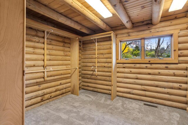 10560 Plaza Ct, Jerome, MI 49249 - spare room with wooden ceiling with exposed beams, carpet flooring, and log walls