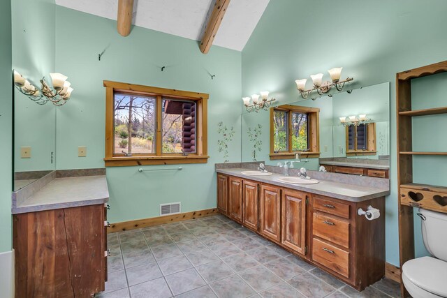 10560 Plaza Ct, Jerome, MI 49249 - bathroom with a chandelier, double vanity, baseboards, toilet, and beamed ceiling