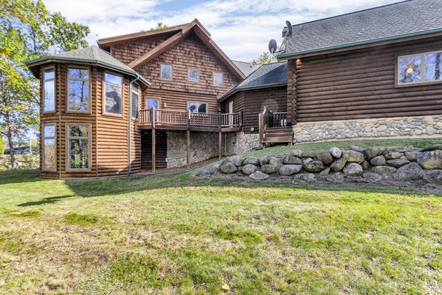 10560 Plaza Ct, Jerome, MI 49249 - back of house with a deck, a lawn, log siding, roof with shingles, and stone siding