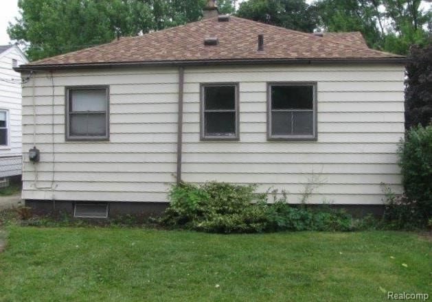 view of property exterior featuring a lawn