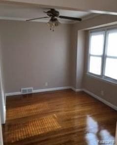 empty room featuring wood-type flooring and ceiling fan