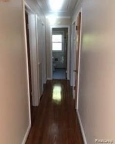 hall with dark hardwood / wood-style flooring and crown molding