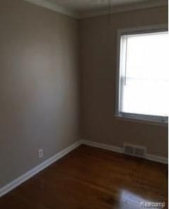 empty room with dark wood-type flooring