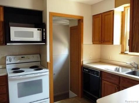 kitchen with sink and white appliances