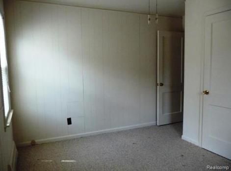 unfurnished room featuring light colored carpet