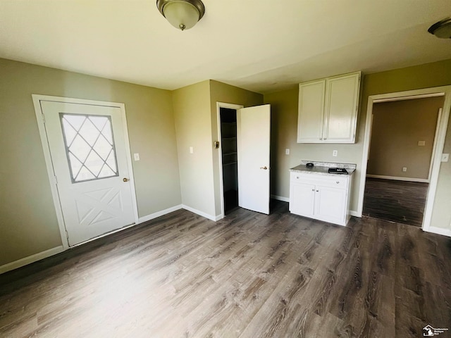 kitchen with white cabinets and wood-type flooring