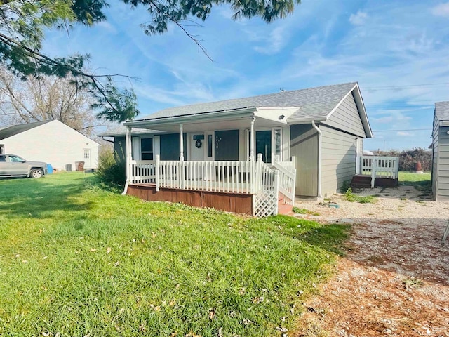 ranch-style home with covered porch and a front lawn