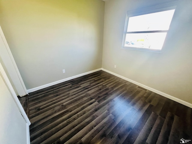 spare room with dark hardwood / wood-style floors