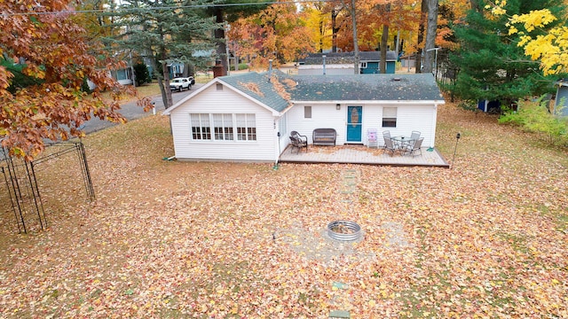 rear view of property featuring a deck