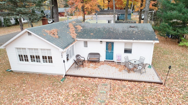 back of house featuring a deck