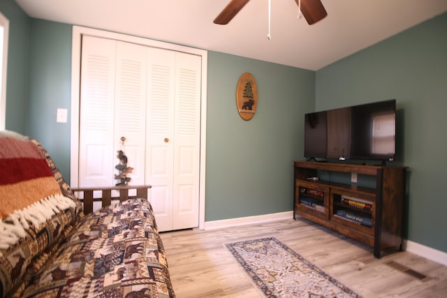 living room featuring ceiling fan and light hardwood / wood-style flooring
