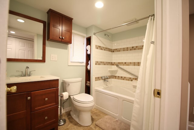full bathroom with tile patterned flooring, vanity, toilet, and shower / bath combo with shower curtain