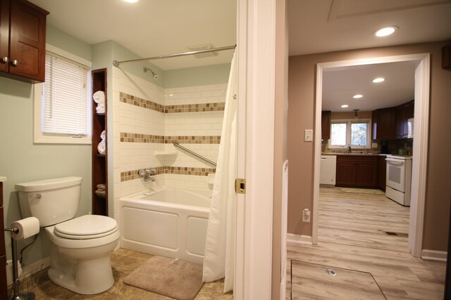 full bathroom with shower / bath combination with curtain, sink, wood-type flooring, and toilet