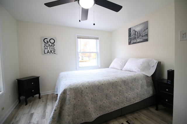 bedroom with ceiling fan and wood-type flooring