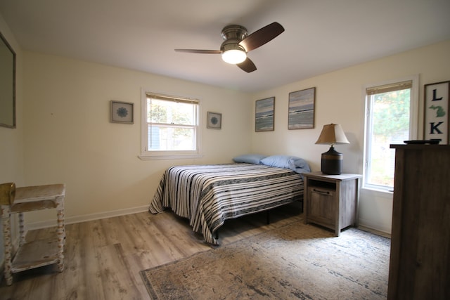 bedroom with ceiling fan and light hardwood / wood-style flooring