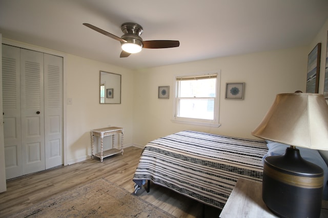 bedroom with light hardwood / wood-style floors, a closet, and ceiling fan