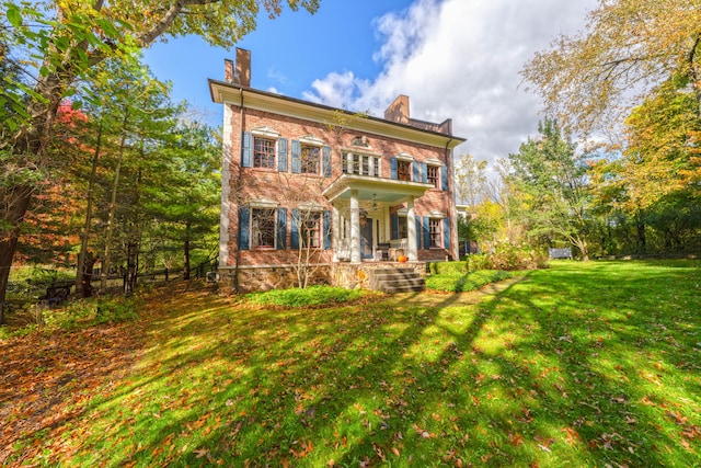 view of front of property with covered porch and a front yard