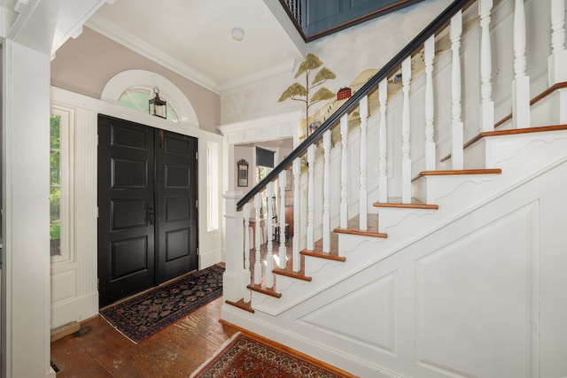 foyer featuring dark hardwood / wood-style flooring and ornamental molding