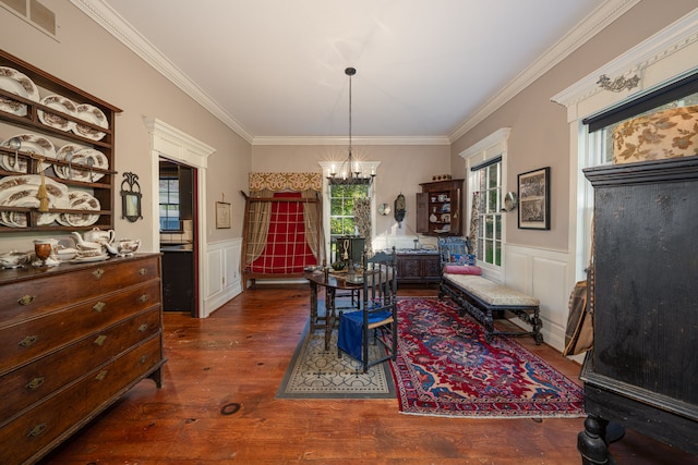 dining space featuring dark hardwood / wood-style flooring, a notable chandelier, and ornamental molding