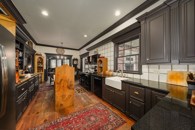 kitchen featuring dishwasher, crown molding, sink, and dark wood-type flooring