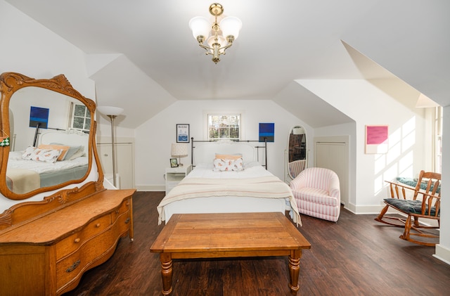 bedroom with dark hardwood / wood-style flooring, vaulted ceiling, and a notable chandelier