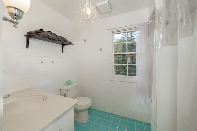 bathroom with vanity, tile patterned floors, a shower with curtain, toilet, and tile walls