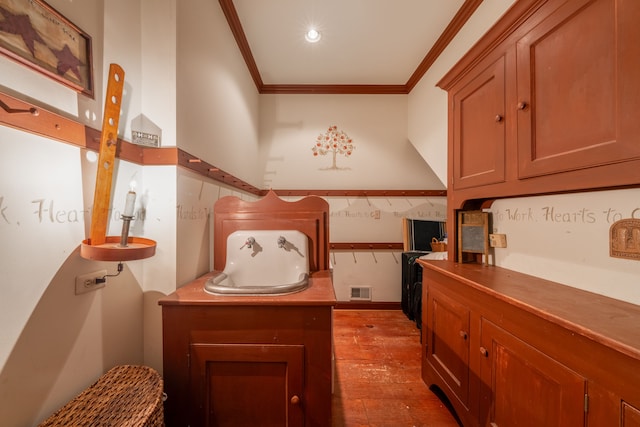 interior space with light hardwood / wood-style floors and ornamental molding