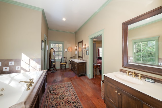 bathroom featuring hardwood / wood-style floors, vanity, a bathtub, and crown molding