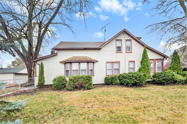 rear view of property with a yard