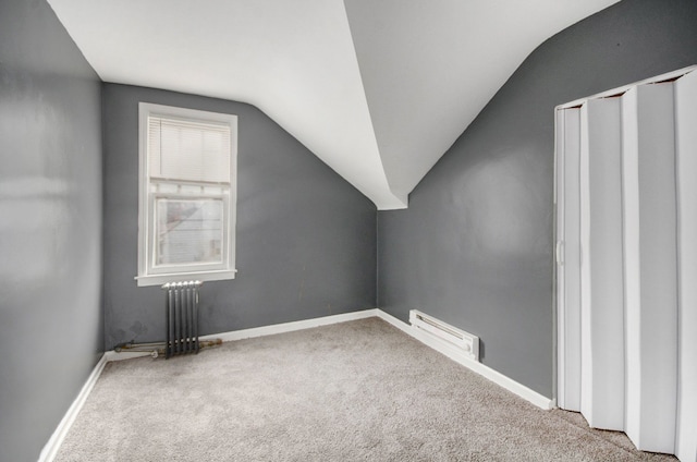 bonus room with carpet floors, radiator heating unit, and vaulted ceiling