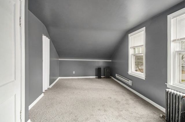 bonus room featuring carpet flooring, vaulted ceiling, and radiator