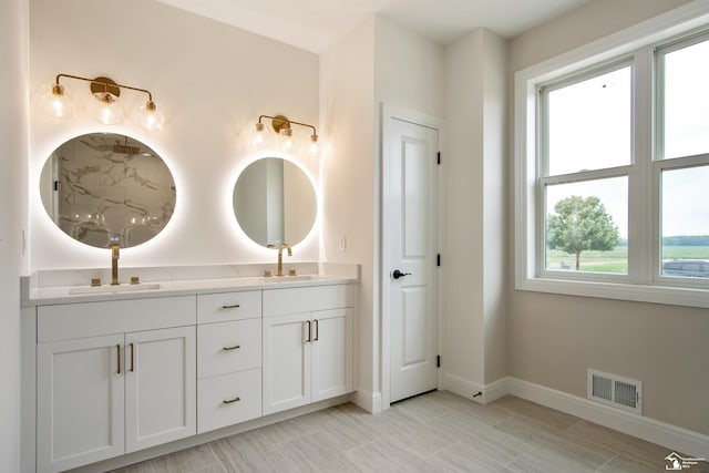 bathroom with vanity and a healthy amount of sunlight