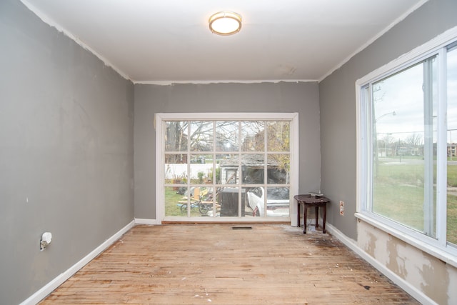 interior space featuring ornamental molding and light hardwood / wood-style flooring