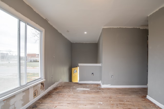 unfurnished room featuring light hardwood / wood-style floors and a wealth of natural light